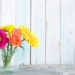 Assorted flowers over a wooden background